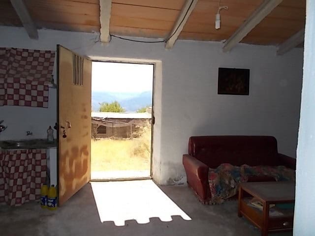 Charming rural home interior with open door to scenic outdoor views in Lucar, Almeria.