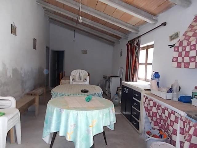 Rural property interior in Lucar, Almeria, featuring a simple living space with basic furniture and.