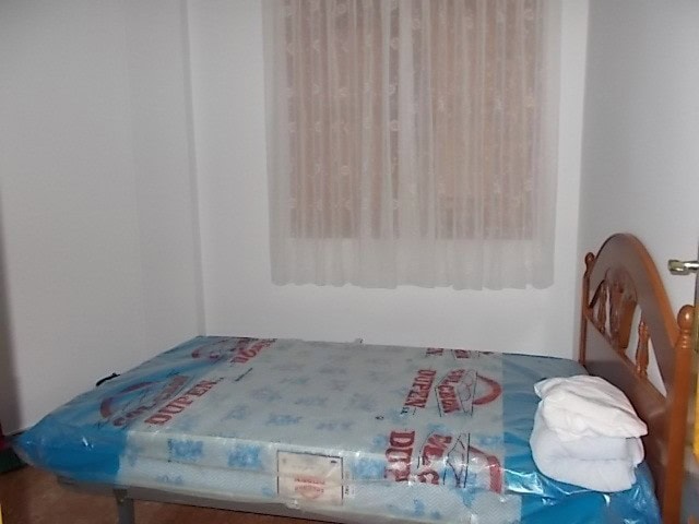 Cozy bedroom in Tijola, Almeria with natural light and simple decor.