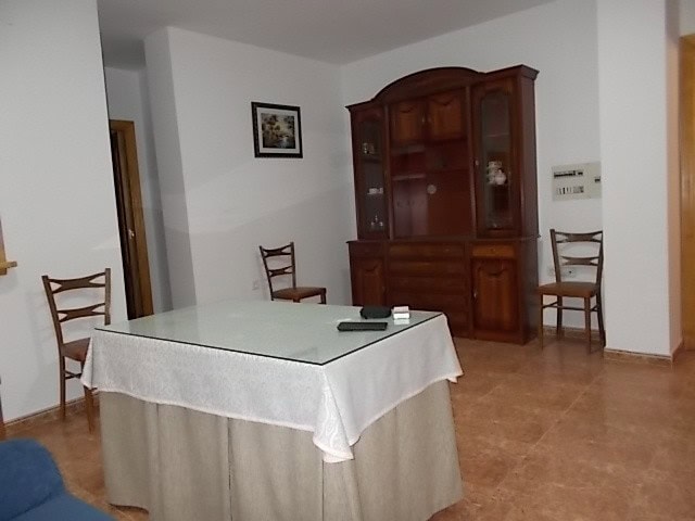 Apartment interior with dining table and wooden furniture in Tijola, Almeria.