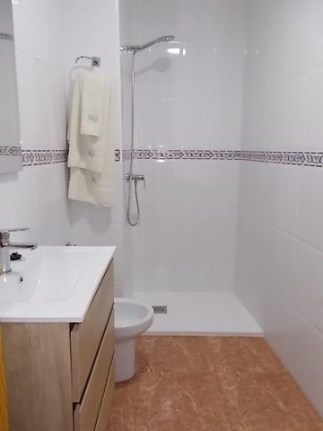 Bathroom with shower, toilet, and vanity in Tijola, Almeria.