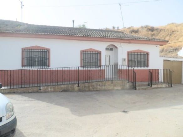 Cave house in Benamaurel, Granada with traditional design and iron window bars.