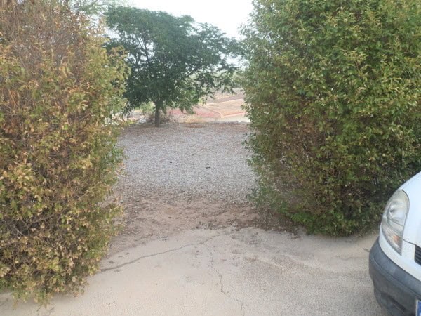 Charming cave house located in Benamaurel, Granada, surrounded by lush greenery and scenic views.