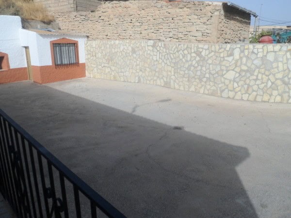 Cave house located in Benamaurel, Granada, with stone walls and a simple exterior.