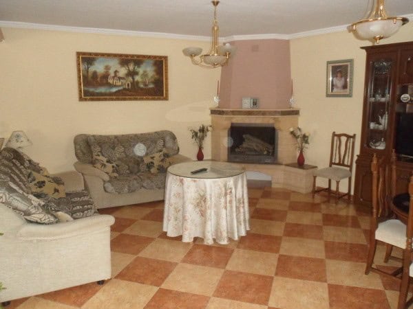Cozy cave house interior with traditional decor in Benamaurel, Granada, featuring a fireplace and vi.