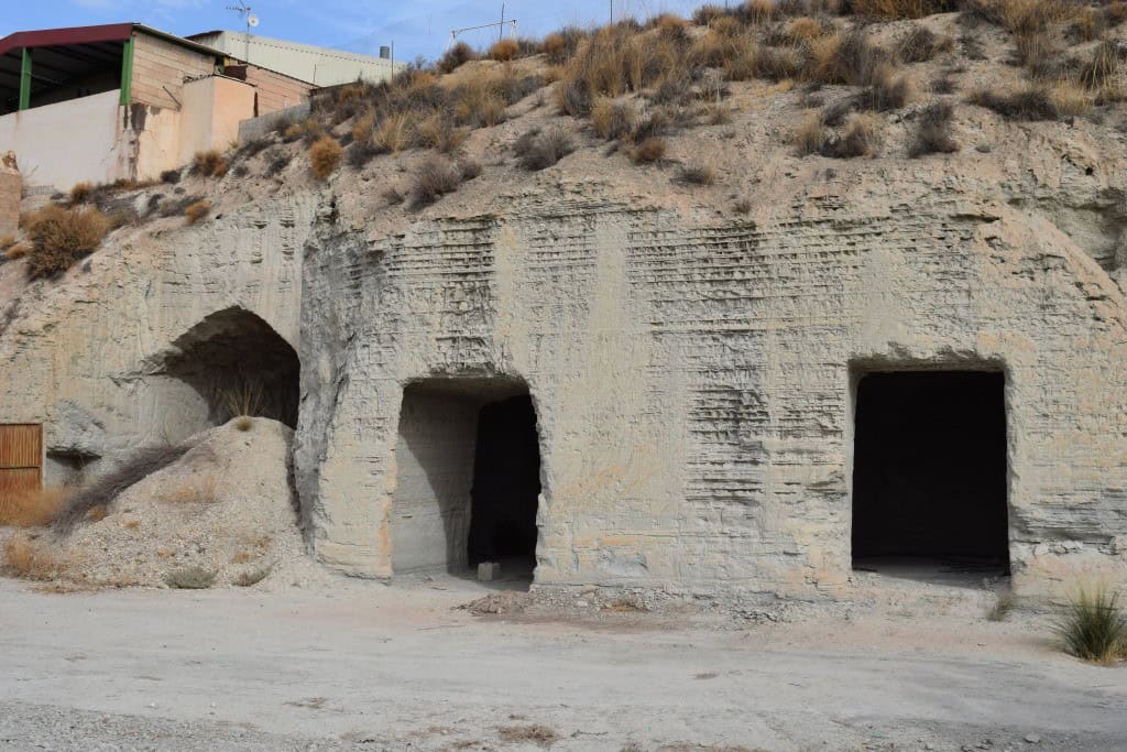 Cave house with three dark entrances built into a hillside in Benamaurel, Granada. Rustic and unique.