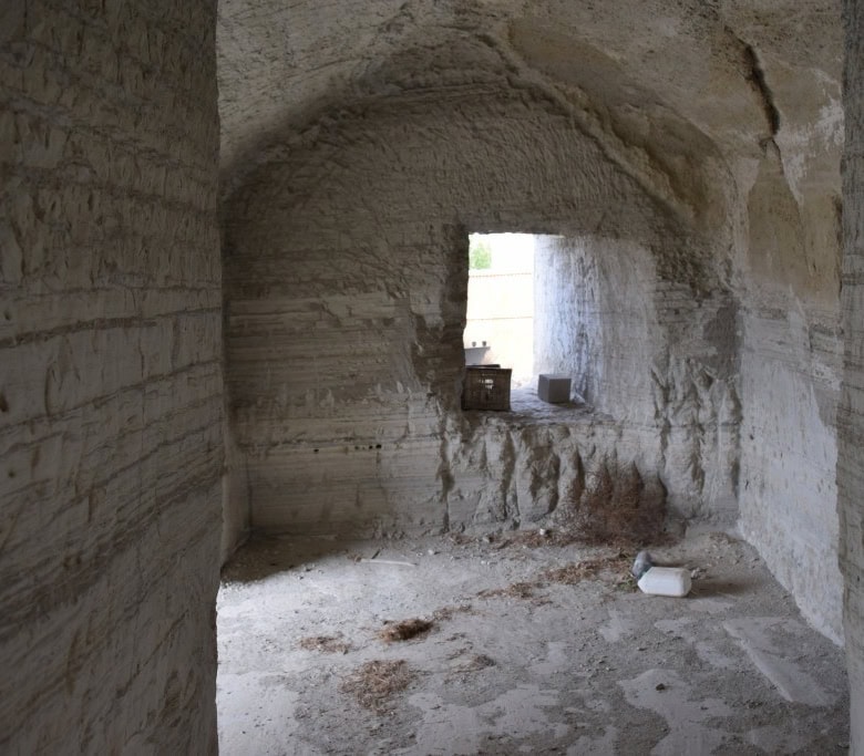 Ancient cave house interior in Benamaurel, Granada, showcasing natural stone walls and rustic charm.