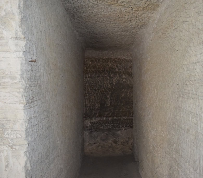 Ancient cave house interior with stone walls in Benamaurel, Granada, showcasing traditional architec.
