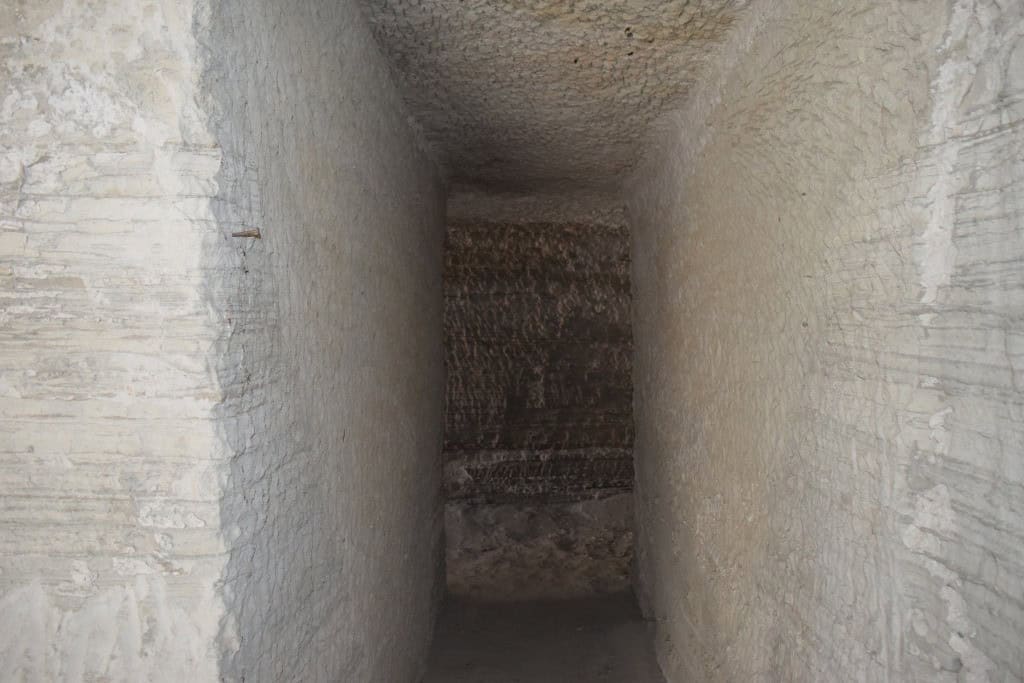 Ancient cave house interior with stone walls in Benamaurel, Granada, showcasing traditional architec.