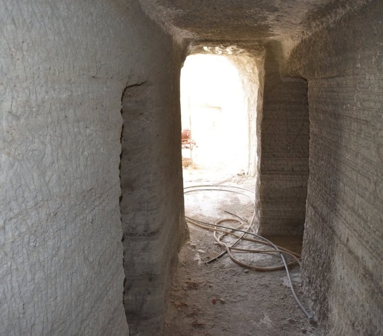 Cave house interior under construction in Benamaurel, Granada, with exposed stone walls and construc.