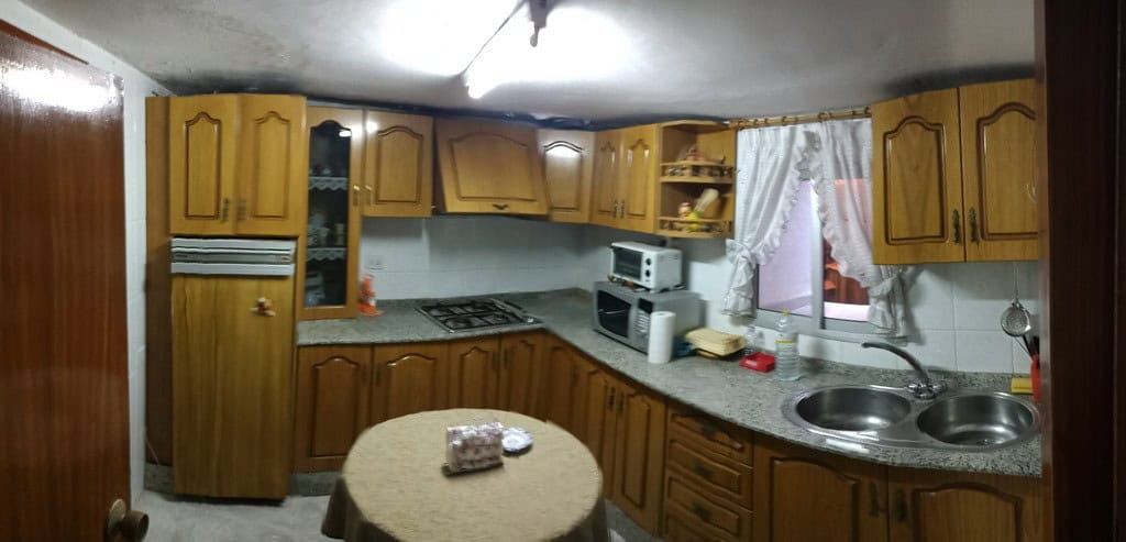 Cozy kitchen in a town house located in Baza, Granada, featuring wooden cabinets, a microwave, and a.