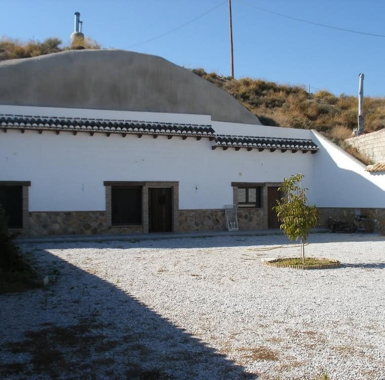 Cave house in Benamaurel, Granada, with whitewashed exterior and traditional architecture.