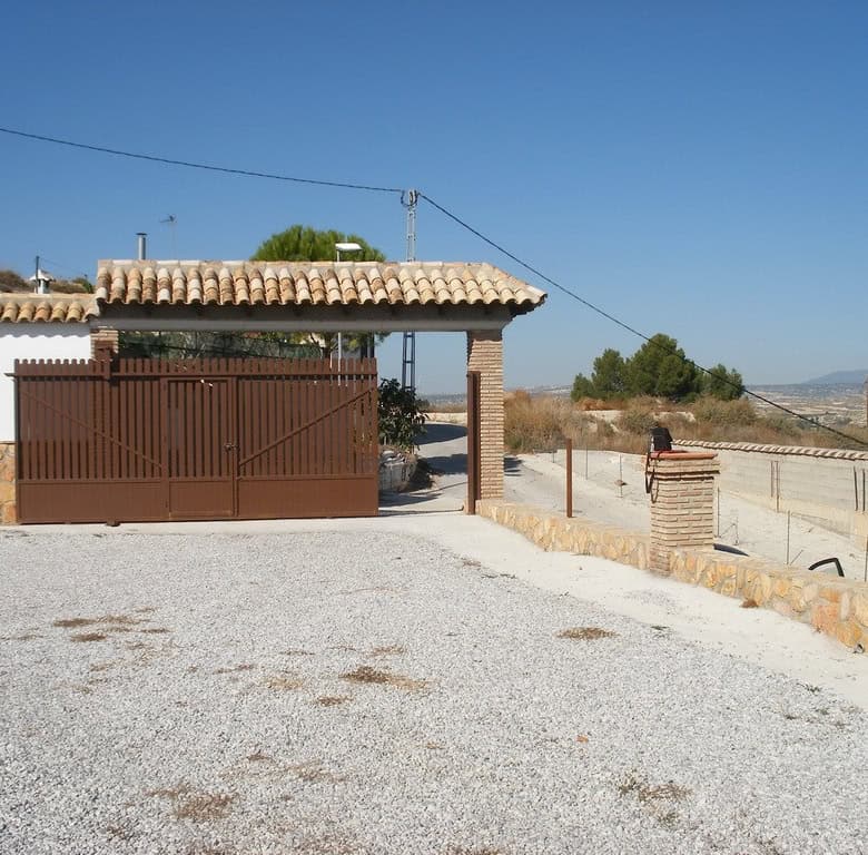 Cave house with traditional tiled roof in Benamaurel, Granada, offering unique rural living.