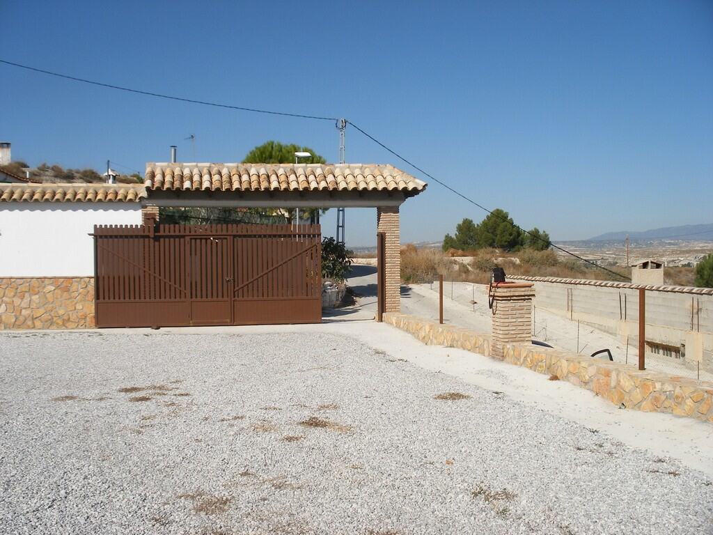Cave house with traditional tiled roof in Benamaurel, Granada, offering unique rural living.