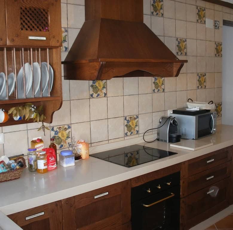 Cozy kitchen of a cave house in Benamaurel, Granada, featuring traditional wooden cabinets and moder.