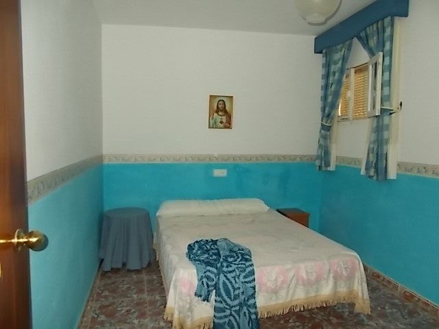 Charming bedroom in Tijola town house, Almeria with bright decor and traditional style.