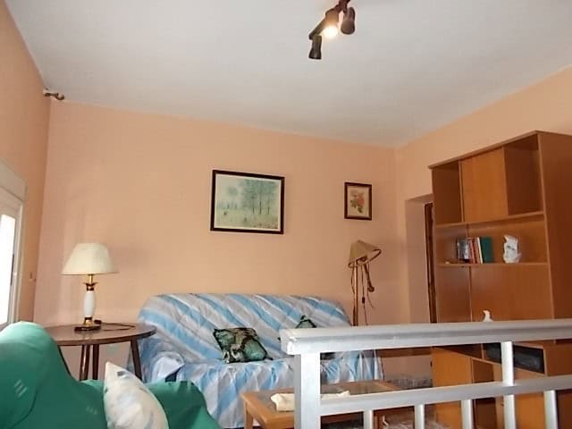 Charming living room of a town house in Tijola, Almeria, featuring comfortable seating, warm lightin.