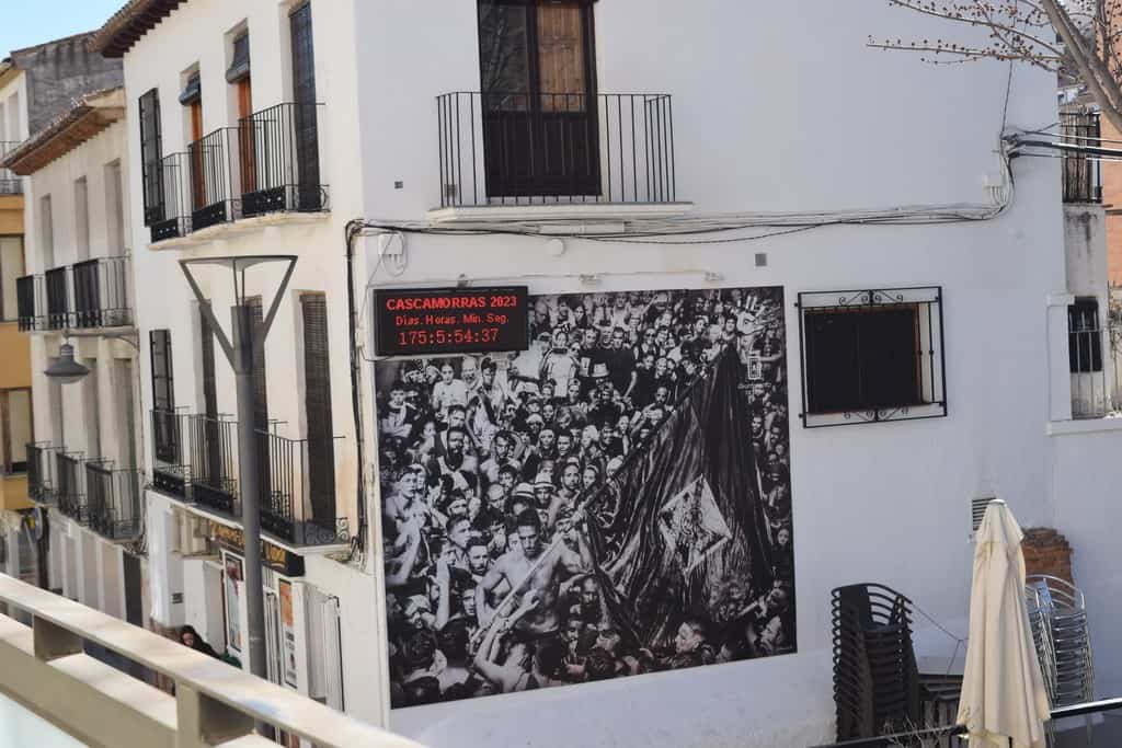 Commercial building in Baza, Granada with modern balconies and white facade.