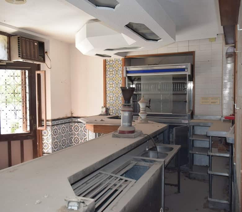 Commercial property for sale in Baza, Granada, featuring a spacious interior with kitchen equipment.