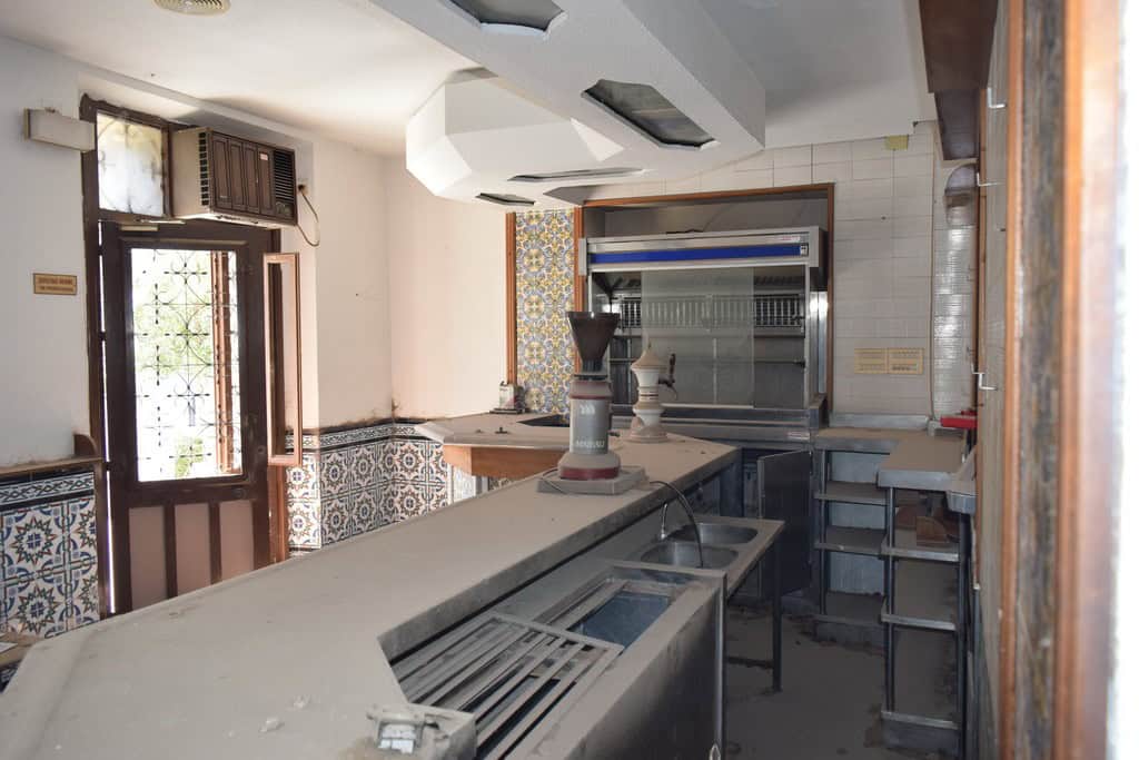 Commercial property for sale in Baza, Granada, featuring a spacious interior with kitchen equipment.