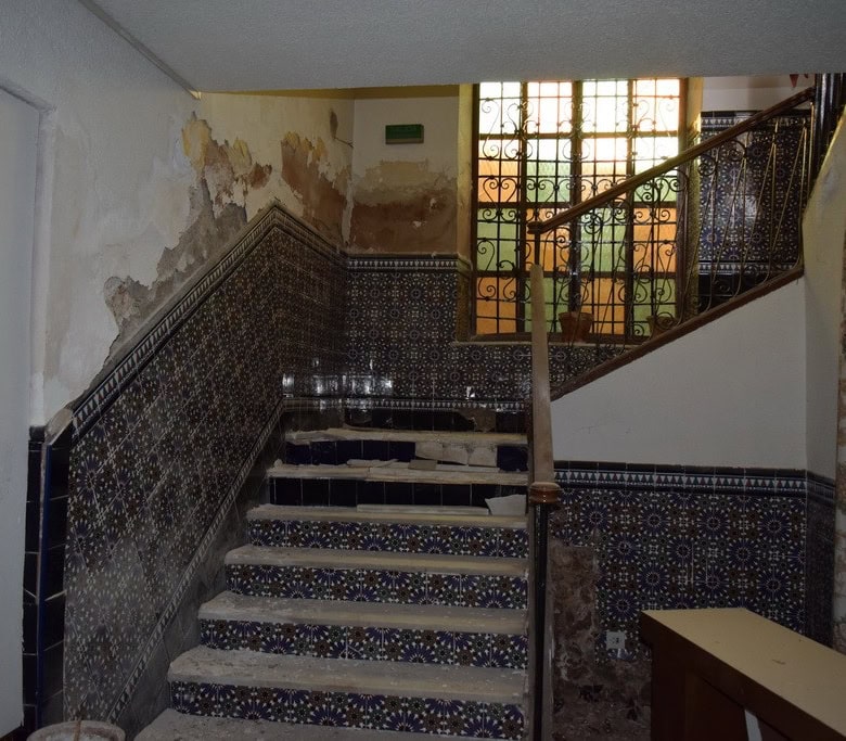 Historic commercial space in Baza, Granada with traditional tile details and rustic interior feature.