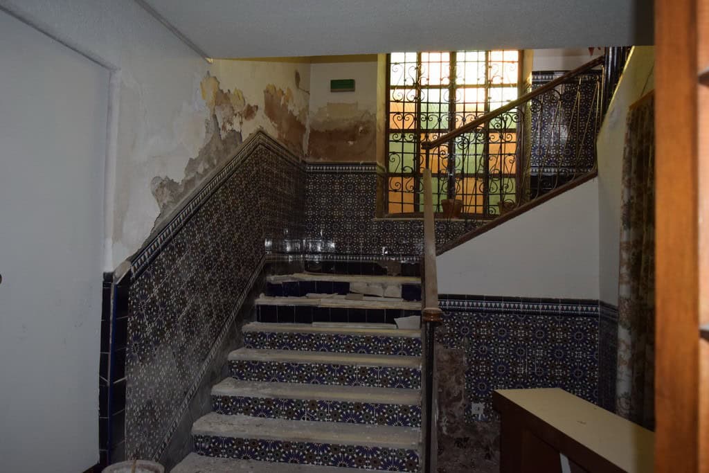 Historic commercial space in Baza, Granada with traditional tile details and rustic interior feature.