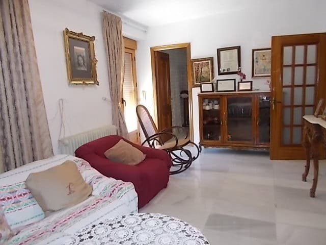 Cozy living room with vintage furniture and decorative art in a traditional Lucar town house.