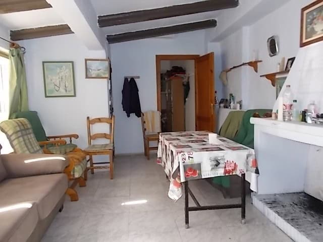 Cozy living room of a town house in Lucar, Almeria with traditional decor and wooden beams.