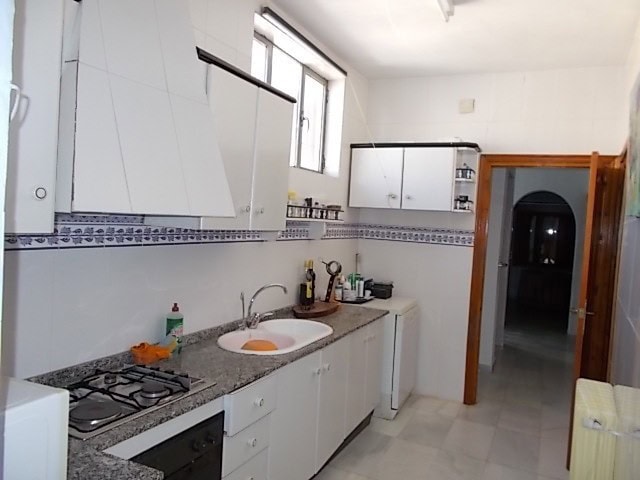 Charming kitchen in a Lucar town house with modern appliances and bright natural light.