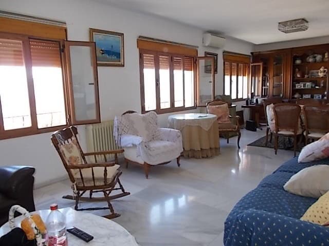 Charming living room of a town house in Lucar, Almeria, featuring wooden window shutters, vintage fu.