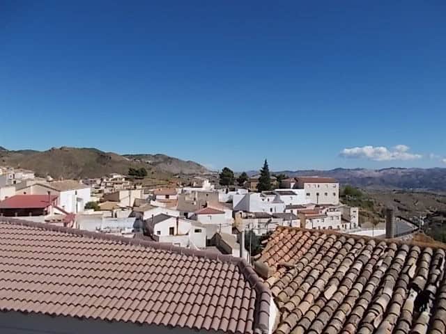 Charming town house in Lucar, Almeria with scenic mountain views and traditional tiled roofs.