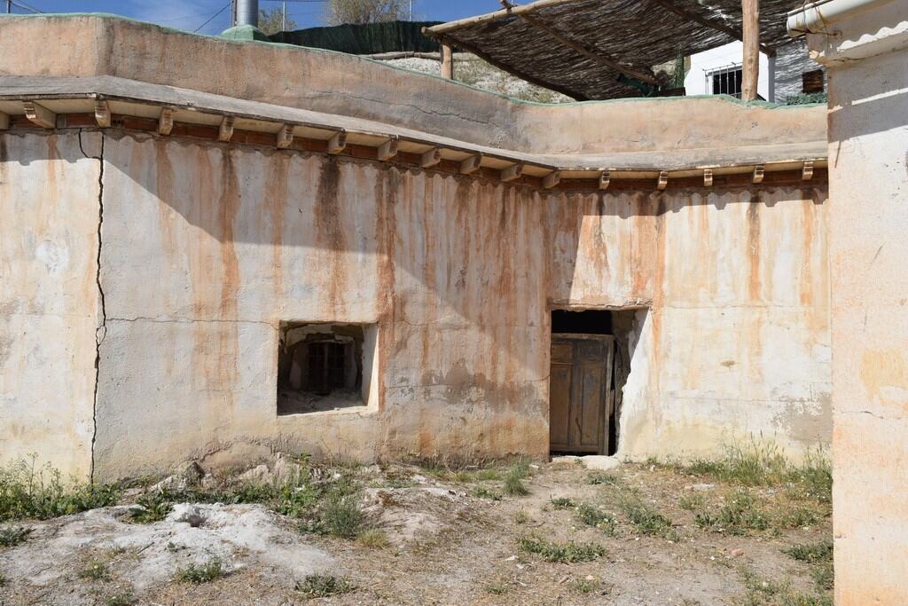 Cave house exterior in Baza, Granada, showcasing traditional adobe construction and rustic charm.