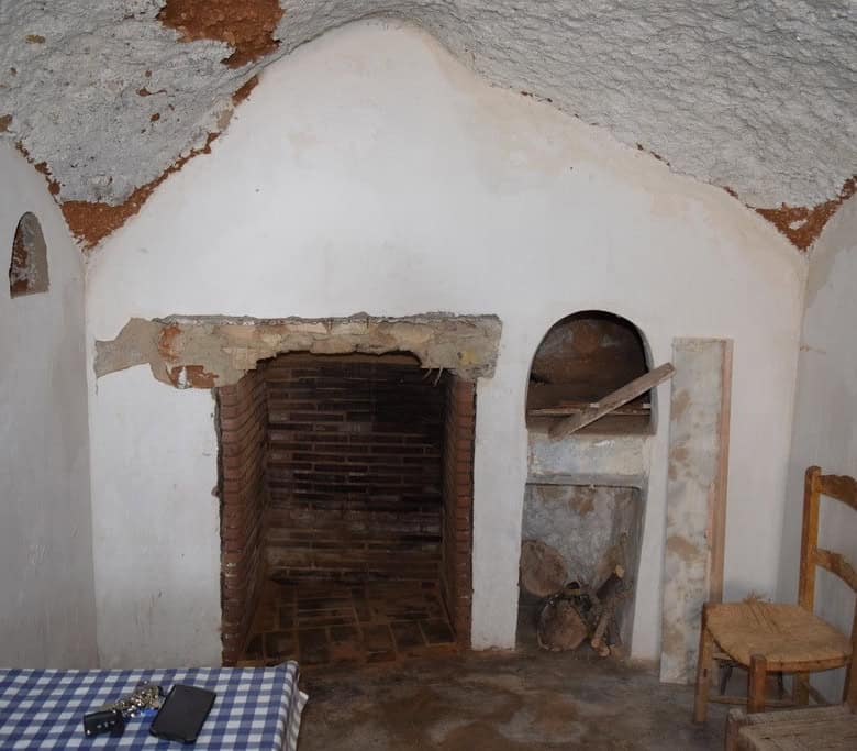 Cave house interior in Baza, Granada, showcasing traditional architecture and rustic charm.
