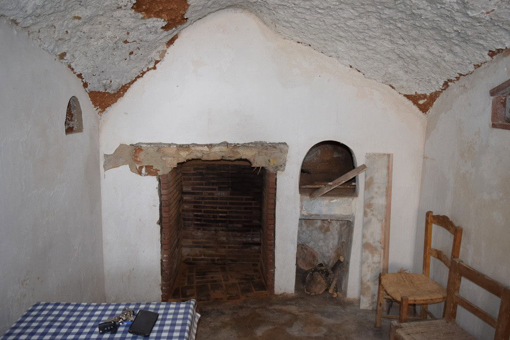 Cave house interior in Baza, Granada, showcasing traditional architecture and rustic charm.