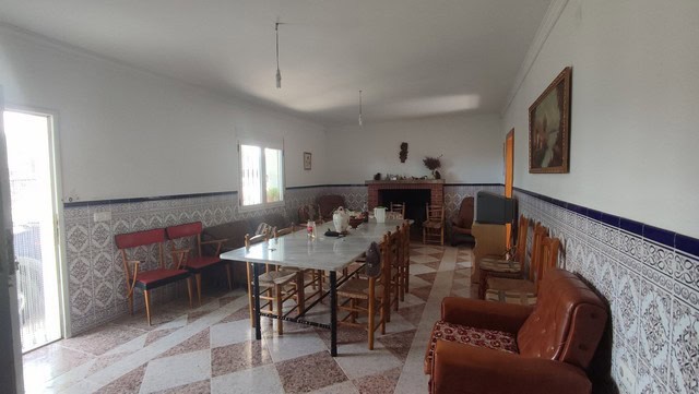 Traditional Spanish interior with spacious living area and rustic decor.