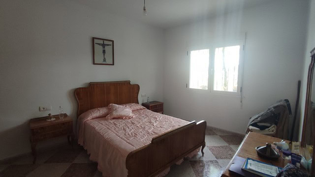 Bedroom in rural property, Somontin, Almeria, Spain, with simple furnishings and natural light.