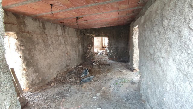 Interior view of unfinished rural property in Tijola, Almeria, showing concrete walls and ceiling un.