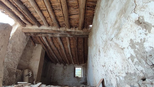Interior of rustic rural property in Tijola, Almeria with traditional wooden ceiling and stone walls.