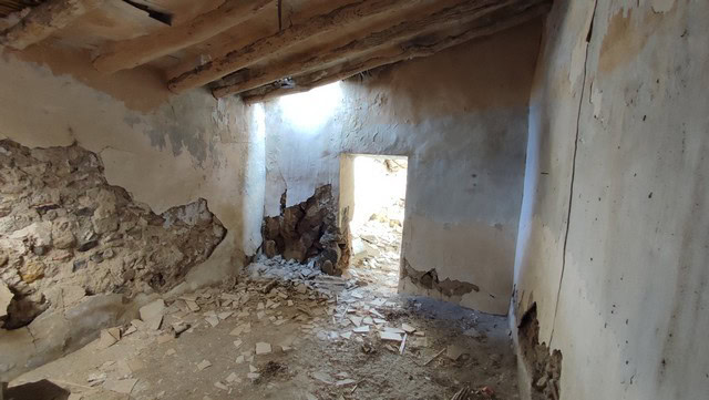 Rural property ruin in Tijola, Almeria with exposed stone walls and wooden beams.