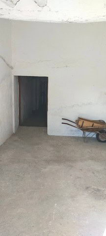 Rural property with white walls and an open doorway in Benamaurel, Granada.