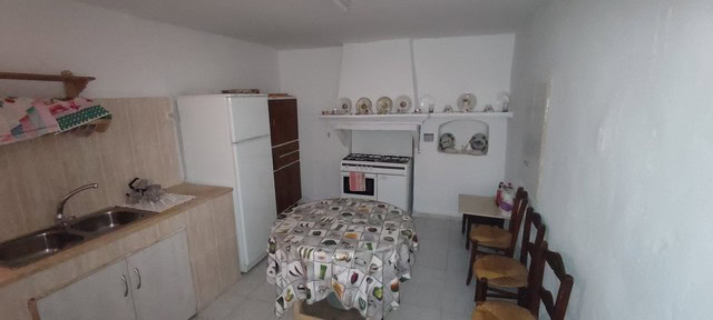 Cozy kitchen with basic appliances and dining area in a village property in Somontin, Almeria.