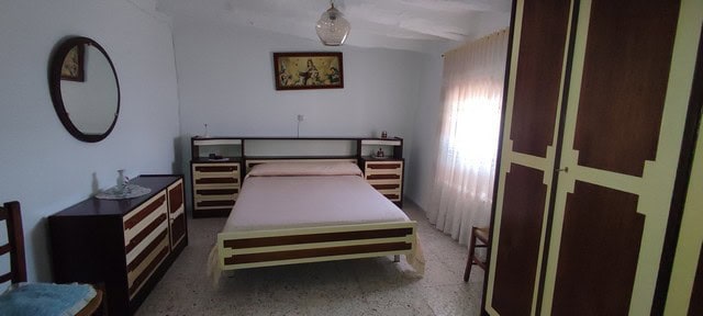 Charming village home in Somontin, Almeria with cozy bedroom and traditional decor.