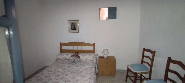 Cozy bedroom in a village property in Somontin, Almeria, featuring simple furnishings and natural li.