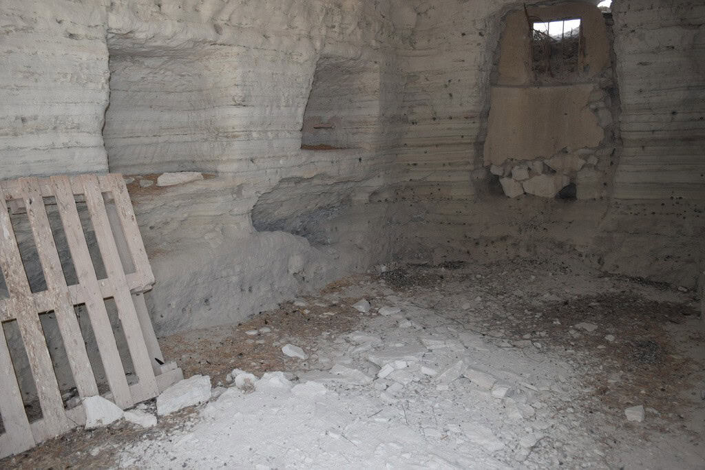 Cave house interior in Baza, Granada, showcasing natural rock walls and rustic charm.