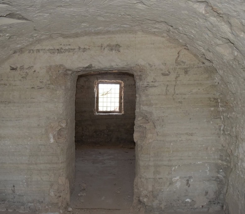 Cave house interior with small window in Baza, Granada, showcasing traditional underground living sp.