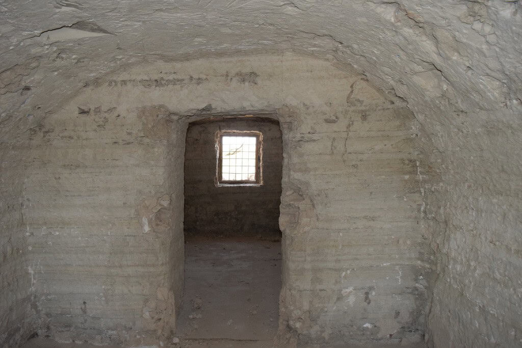Cave house interior with small window in Baza, Granada, showcasing traditional underground living sp.