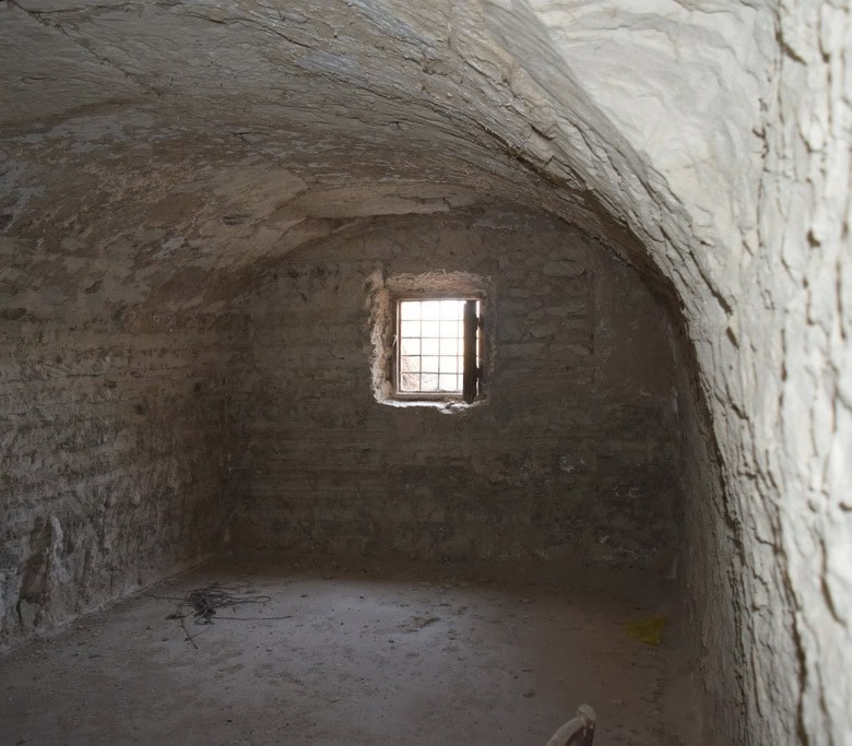 Cave house interior with small window in Baza, Granada, Spain. Unique underground property for sale.