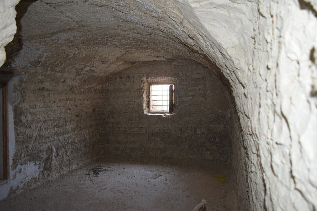 Cave house interior with small window in Baza, Granada, Spain. Unique underground property for sale.