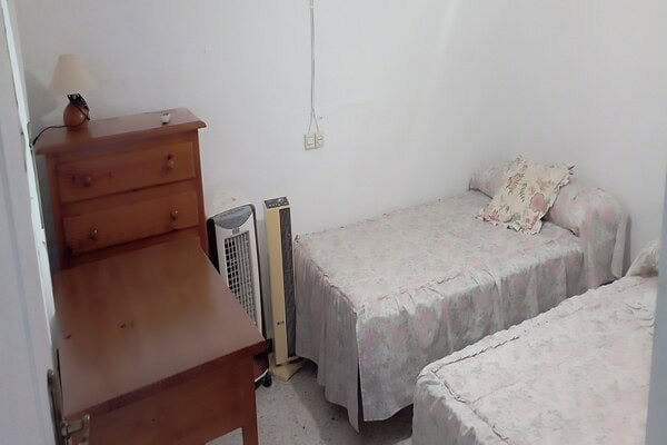 Cozy bedroom in a rural property in Rosales, Jaen with simple furnishings and a peaceful atmosphere.