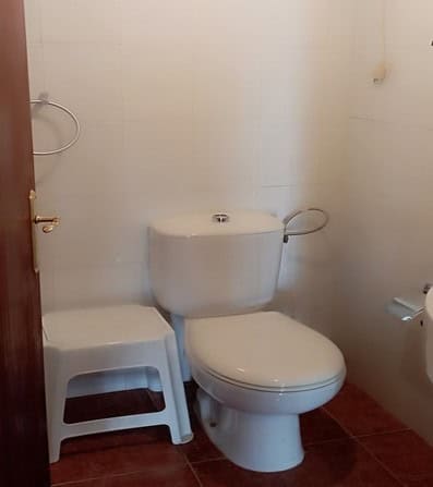 Charming rural property in Rosales, Jaen, featuring a simple bathroom with a toilet and basic fixtur.